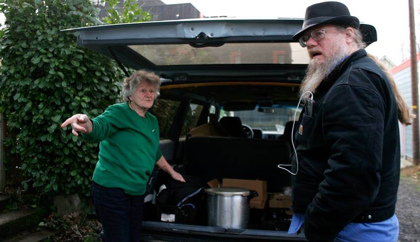 February 4, 2015<br> Photo by Mary Anne Funk<br> Genevieve Cochran asks Pastor Steve Kimes of Anwaim Christian Community, what he has room for in his van as they prepare to head over to St. Johns, for their Wednesday meal service. 