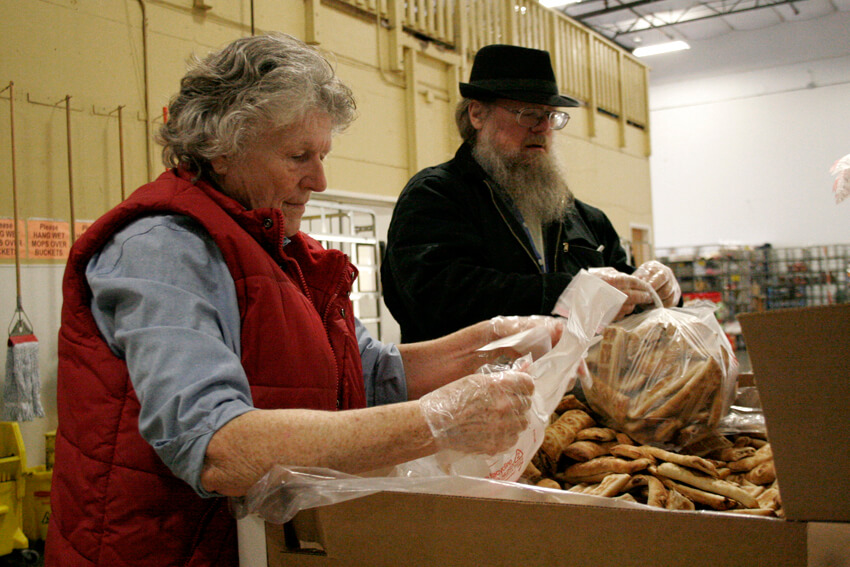 Photo by Mary Anne Funk <br>Genevieve and Steve pick up food items from The Birches. 