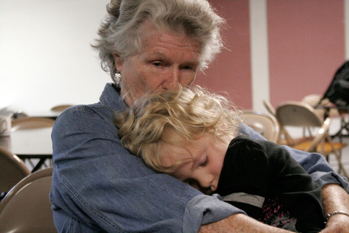 Genevieve comforts Paloma during the meal service in St. Johns, Oregon. Paloma wasn't feeling well that day. Photo - Mary Anne Funk