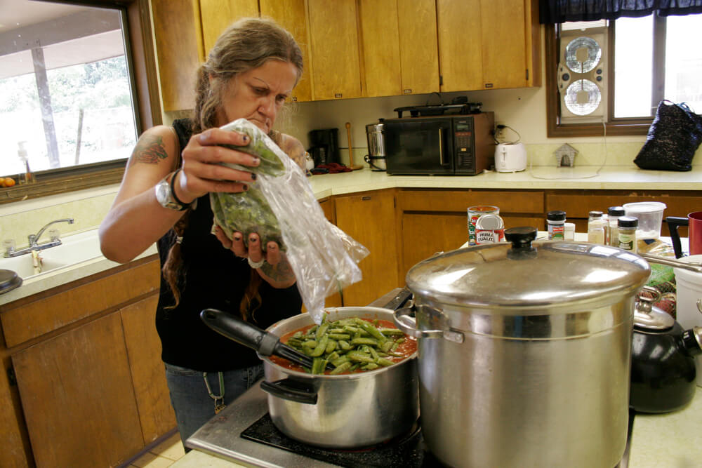 Finding Sanctuary Pat prepares a meal for herself and others, using the Anawim Christian Community's Sanctuary kitchen. Photo by Mary Anne Funk